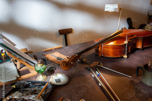Workbench in a luthier's workshop with a string instrument under repair
