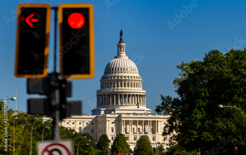 Capitol with red signal, shutdown symbolism. Capitol building as midterm elections concept. US Capitol represents federal budget negotiations. American Capitol symbolizes legislative stalemate.