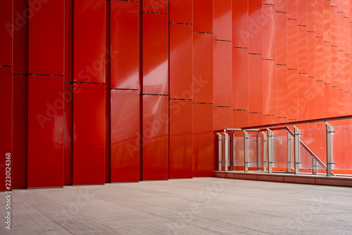 modern red building exterior wall with glass railing and floor