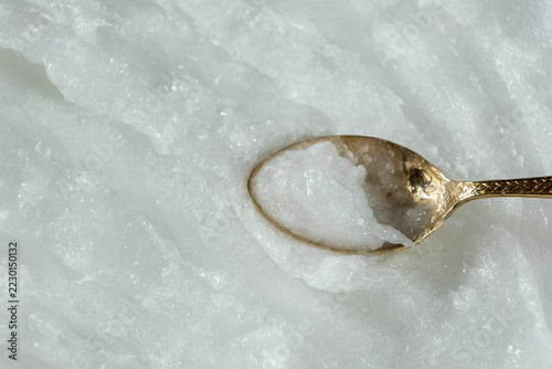 Coconut oil on spoon with copy space background