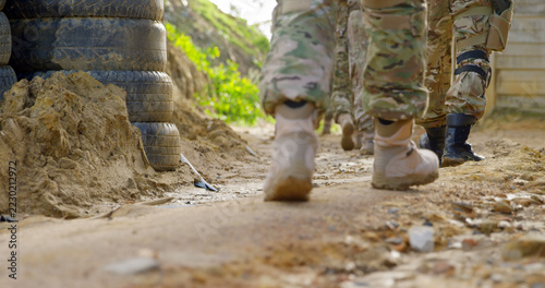 Low section of military soldiers walking during military training