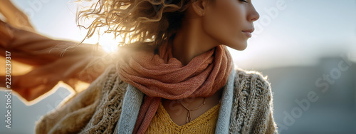 Woman wearing pink scarf with windblown hair outdoors