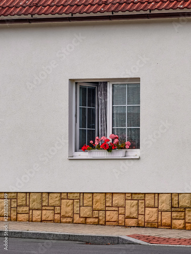 House Exterior with Flower Box and Decorative Stone Facade