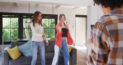 Happy diverse teenager girls using smartphone and making dance video