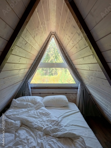 Interior of a attic bedroom in a glamping pod