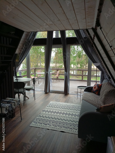Interior of a room with a wooden floor and a window in a glamping pod.