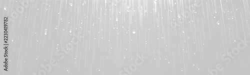 Obraz na plátně Falling water droplets are shown in sharp, elongated streaks against a dark background