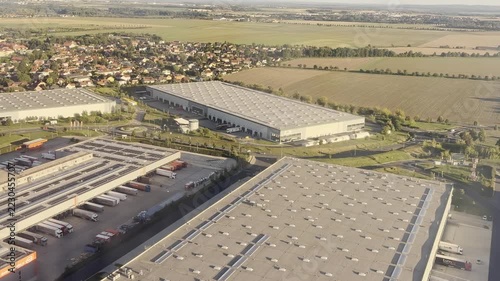 Aerial view of industrial warehouses and distribution center from airplane