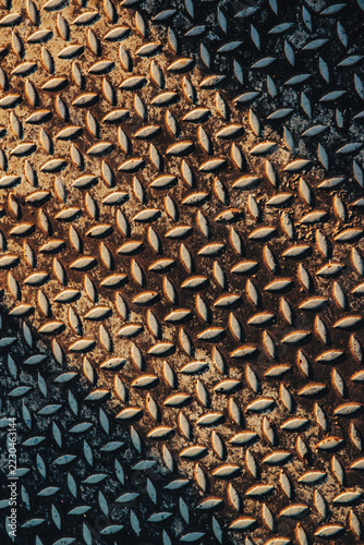 Vertical close up of rusted diamond steel plate texture background