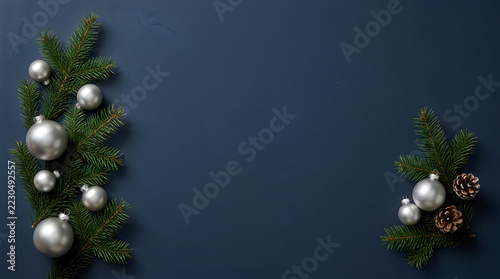 Elegant silver baubles pine cones fir branches holiday decoration flat lay