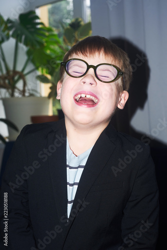 Boy wearing glasses laughs