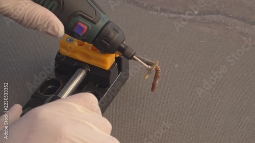 Cordless rotary tool craftsman select speed level 6. wearing gloves 
holding a cordless rotary tool equipped with a mini metal wire brush 
wheel attachment.