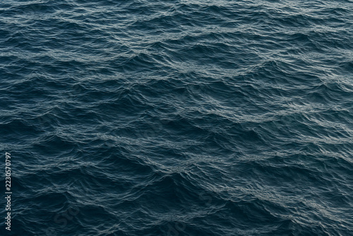 Dark blue ocean ripples with subtle silver reflections