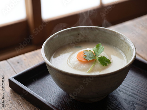 Close-Up of Kansai-Style White Miso Zoni Soup with Round Mochi in Ceramic Bowl