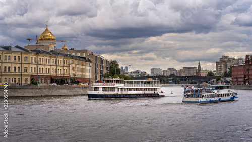 Photography Passenger boats cruising the Moskva River beside central Moscow architecture