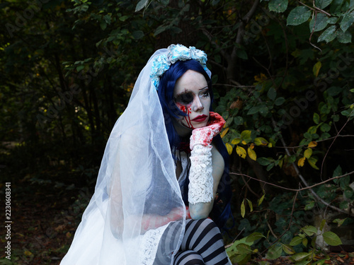 sad ghost bride with blue flower crown sitting in forest, bloody lace glove, gothic halloween