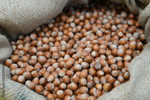 The burlap sack filled with whole unshelled hazelnuts at a market