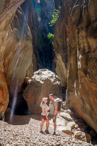 Hiker exploring the towering limestone gorge of Torrent de Pareis in Mallorca, Spain