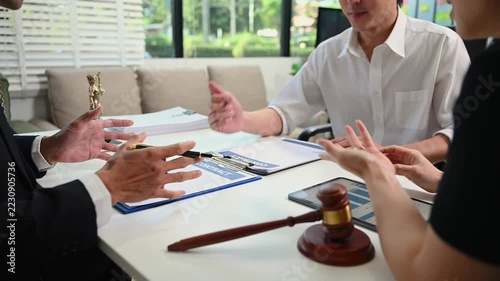 Business and lawyers discussing contract papers with brass scale on desk in office. Law, legal services, advice, justice and law concept .