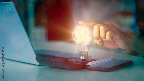Hand touching bright glowing digital brain light bulb for creative thinking, business innovation, and artificial intelligence solution concept.