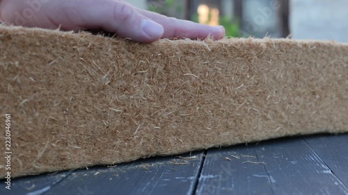 Hand Compressing a Wood Fiber Insulation Batt to Check Resilience