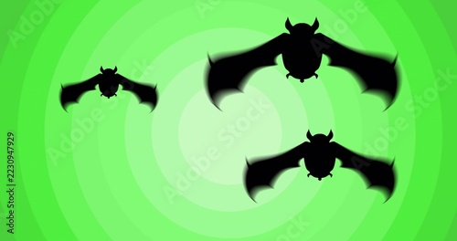 Soaring three black bat silhouettes across green concentric rings in graphic art, blurring wingtips