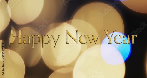 Shimmering gold Happy New Year text floating on banner bokeh discs with blue-violet highlight