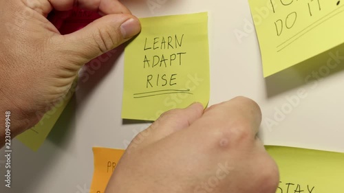 LEARN ADAPT RISE Message on a Yellow Sticky Note