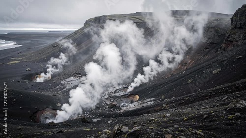 Steam rising from volcanic vents on a coastal mountains slope
