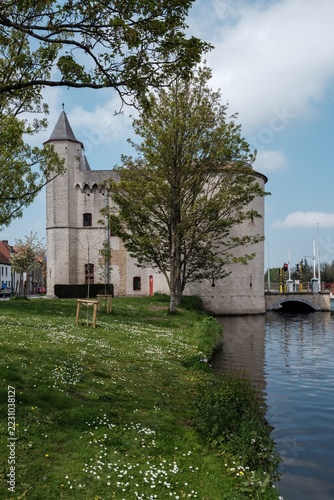Church on the river bank in Bruges city