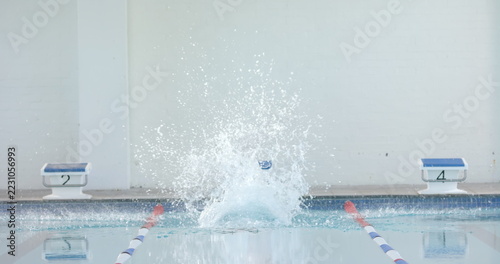 Swimmer making a splash in an indoor pool