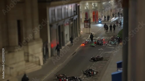 Paris street after protest showing overturned scooters and debris