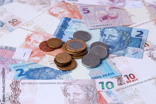 Brazilian real money notes and coins on table. Brazil cash bills of BRL currency close up