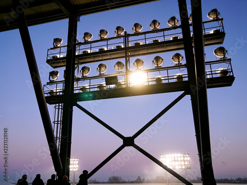 Stadium Floodlights Against Twilight Sky Before Evening Sports Match