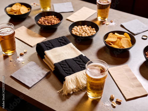 Overhead Pub Table Prepared for a Football Watch Party with Snacks and Drinks
