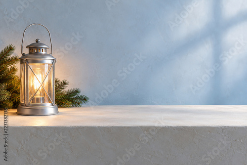 Plain Christmas lantern glows electrically beside a clear product