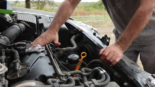 A person cleaning the engine