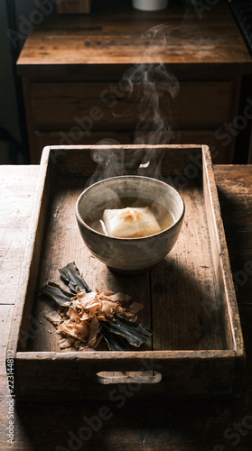 Traditional New Year Mochi Soup with Clear Broth, Kelp and Bonito Flakes on Wooden Tray