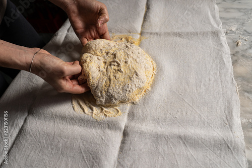 Hands Shaping Rustic Bread Dough on a Flour-Dusted Cloth