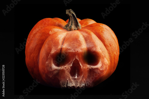 Halloween Pumpkin with Human Skull Face on Black Background