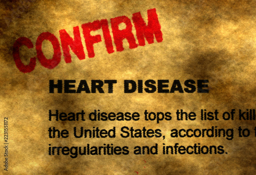 Confirmed Heart Disease Diagnosis Concept with Red Stamp on Medical Document