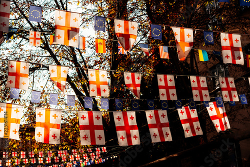 Fotografie Flags of Georgia and EU seen in the streets of old town Sololaki in Tbilisi, Georgia