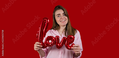 St Valentines concept. Woman with love sign balloon