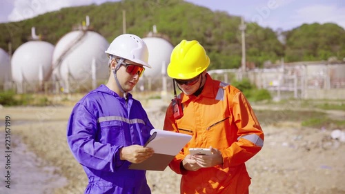 Engineers reviewing plant inspection plant data on clipboard and tablet