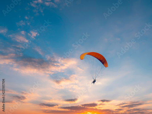 Paraglider on a sunset sky