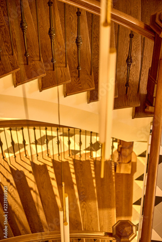 Fotografie Wooden Staircase with Railings and Lighting Fixture