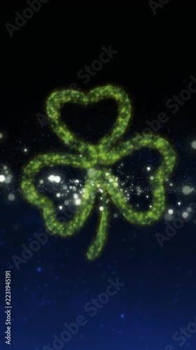 Vertical video: Sparks rising spurring green bursting, dots forming shamrock, glow drifting