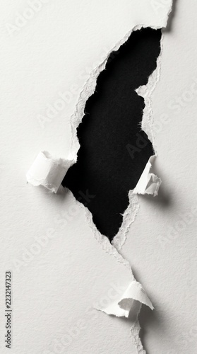 Dramatic Monochrome Paper Rip with Textured White Fibers and Deep Shadows