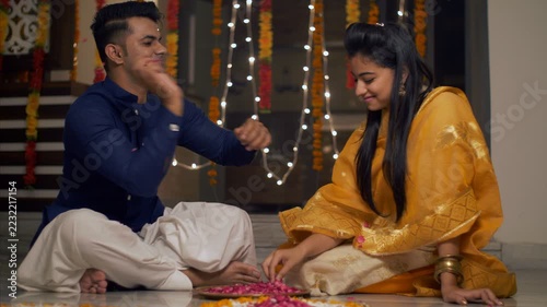 Diwali Rangoli - An Indian family making and playing while making flower rangoli. 