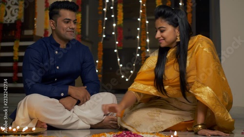 Happy family decorating home for Diwali decoration and sharing happy and light moments during . 